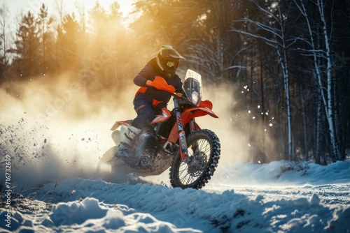 Motocross rider on the snowmobile in the winter forest. Motocross. Enduro. Extreme sport concept. © John Martin