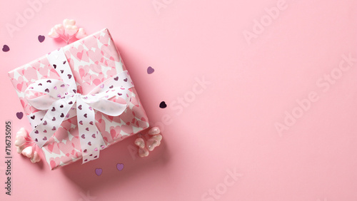 Valentine's Day gift box with hearts on pink background. © photoguns