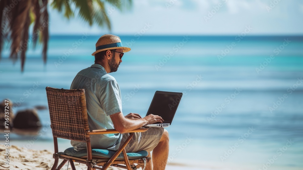 person with laptop on the beach