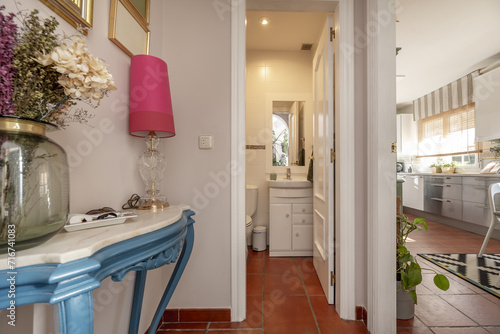 Small modern design bathroom with white wooden furniture with porcelain sink and white wooden framed mirror