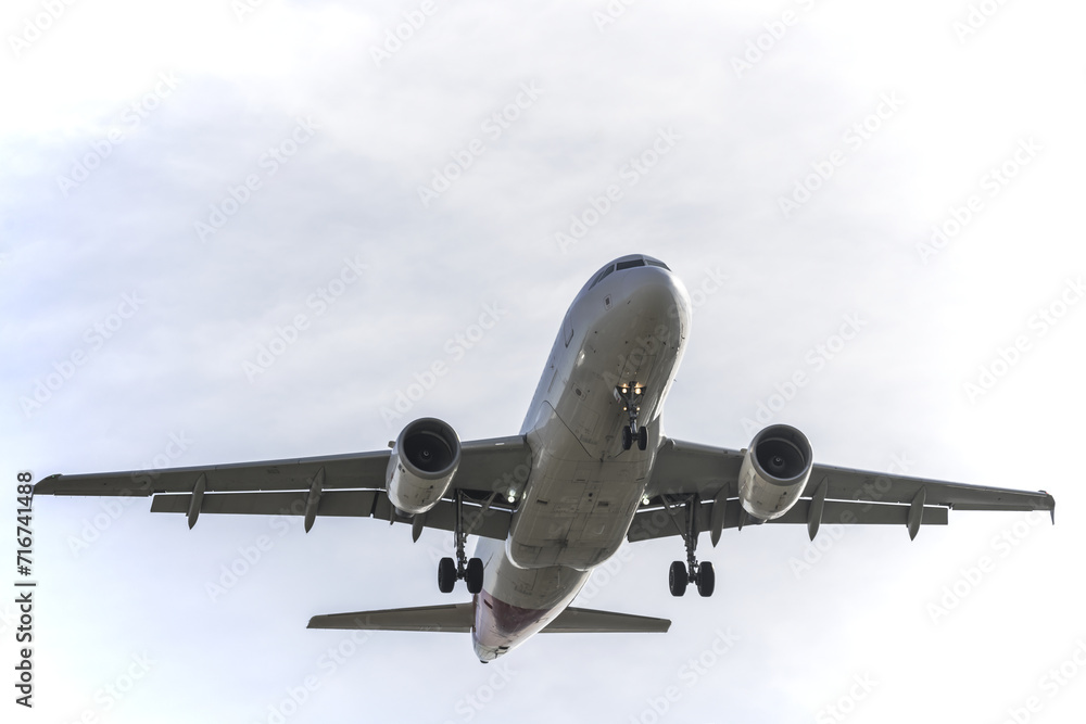 a passenger plane with landing gear deployed approaching