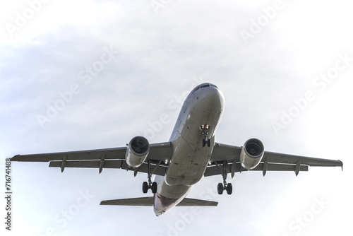 a passenger plane with landing gear deployed approaching