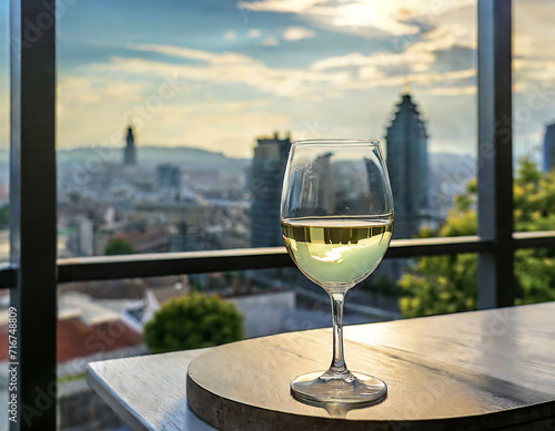 A glass of white wine against the backdrop of the evening city