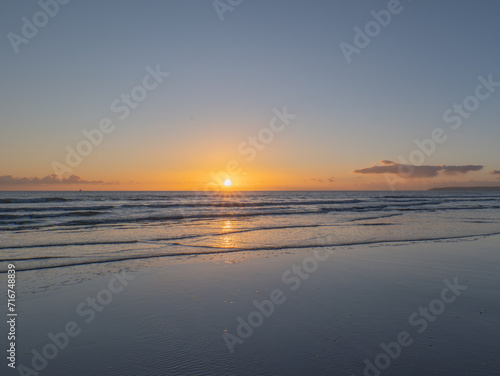 Mesmerizing beach sunset with vibrant colors  tranquil waves  and coastal beauty  ideal for relaxation  travel  golden skies