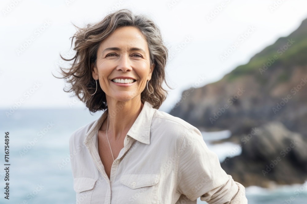 Portrait of a cheerful afro-american woman in her 60s donning a classy polo shirt against a rocky shoreline background. AI Generation Portrait of a cheerful afro-american woman in her 60s donning a classy polo shirt against a rocky shoreline background. AI Generation