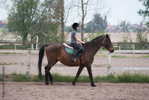 Teenage girl riding a horse