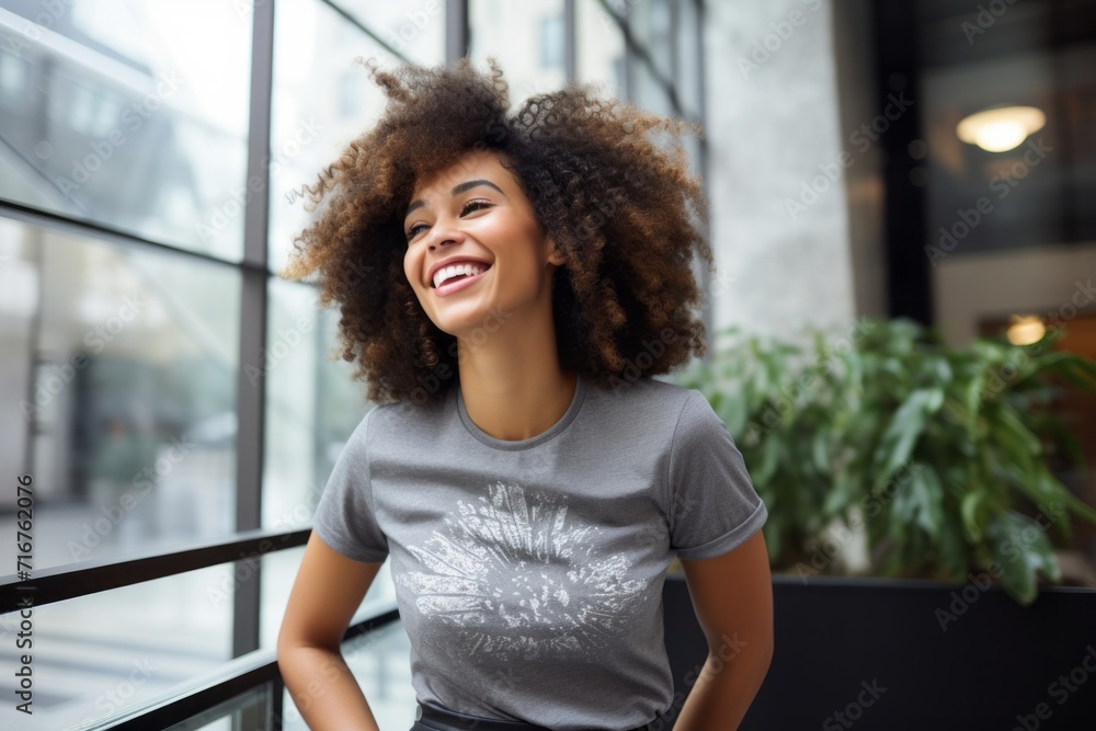 Portrait of a joyful afro-american woman in her 30s sporting a vintage band t-shirt against a sophisticated corporate office background. AI Generation