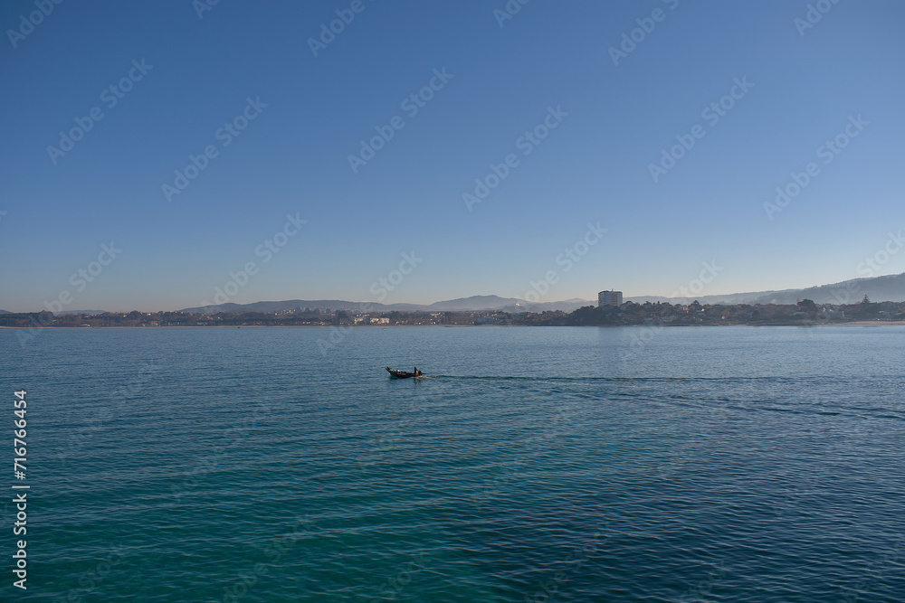 A small boat sailing through the Ria de Vigo