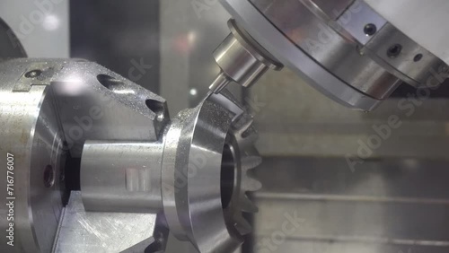 The 5-axis CNC milling machine  cutting the automotive part with solid ball end mill tool. The hi-technology automotive part manufacturing process by CNC lathe.