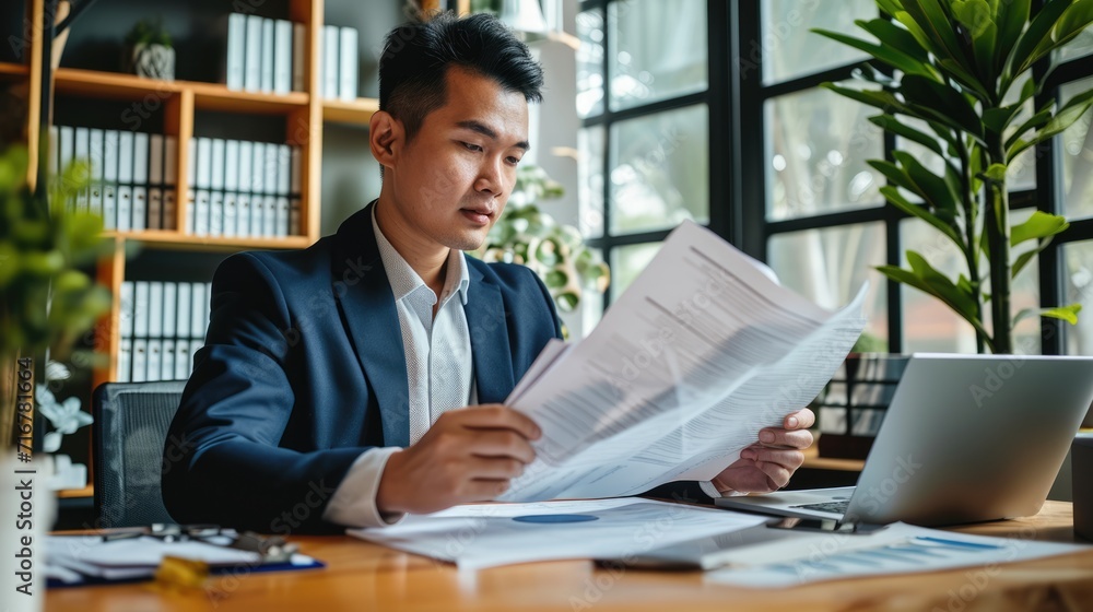 Young busy business man lawyer, tax accountant manager holding paper documents checking bills, doing sales invoice accounting Young busy business man lawyer, tax accountant manager holding paper documents checking bills, doing sales invoice accounting