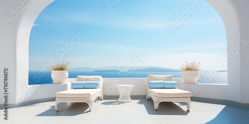 Two sunbeds on white terrace with arch. Traditional mediterranean architecture under blue clear sky. Summer vacation background.
