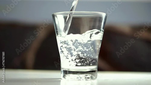 pour water into a clear glass photo