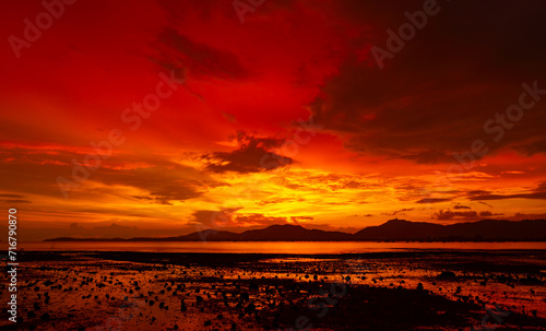 Beautiful colorful sunset or sunrise sky over sea with dramatic clouds nature environment background © panya99