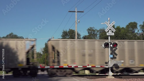 Freight train passes a road railway crossing, USA