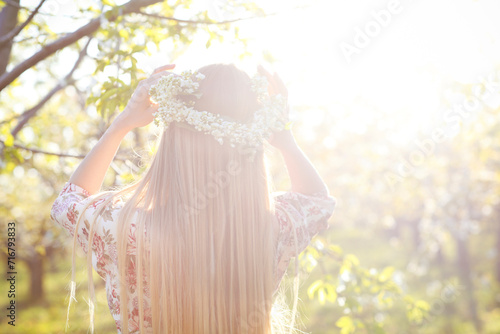Beautiful romantic woman with long blond hair in a wreath photo