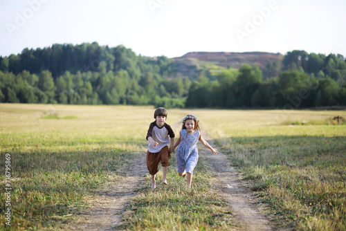 Children walk in the summer in nature. Child on a sunny spring morning in the park. Traveling with children.