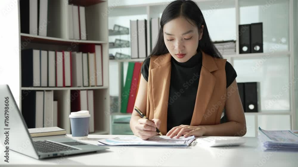 Asian businesswoman doing accounting about project plans and financial results in the office Marketing strategy analysis stock trading financial advisor 4k Asian businesswoman doing accounting about project plans and financial results in the office Marketing strategy analysis stock trading financial advisor 4k