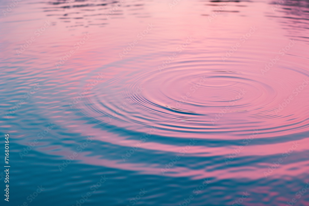 abstract claiming rhythms background of water circles ripples effect in pond reflection color sky pink and blue background. abstract claiming rhythms background of water circles ripples effect in pond reflection color sky pink and blue background.
