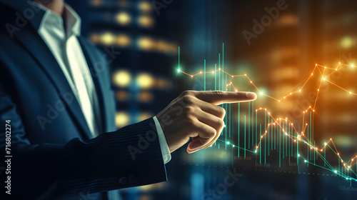 Businessman's hand pointing at stock market graph digital investment ideas