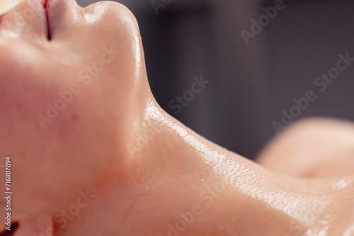 close-up of girl s face and neck with cream or mask during cosmetic procedure in beauty salon