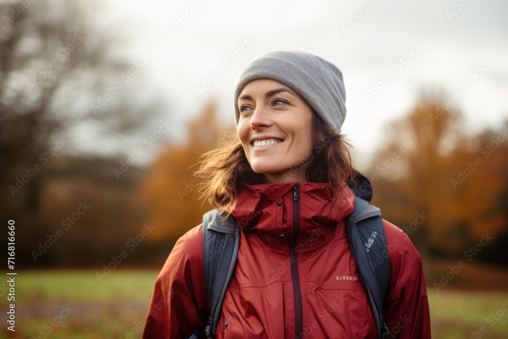 Portrait of a joyful woman in her 30s wearing a windproof softshell against a bright and cheerful park background. AI Generation Portrait of a joyful woman in her 30s wearing a windproof softshell against a bright and cheerful park background. AI Generation
