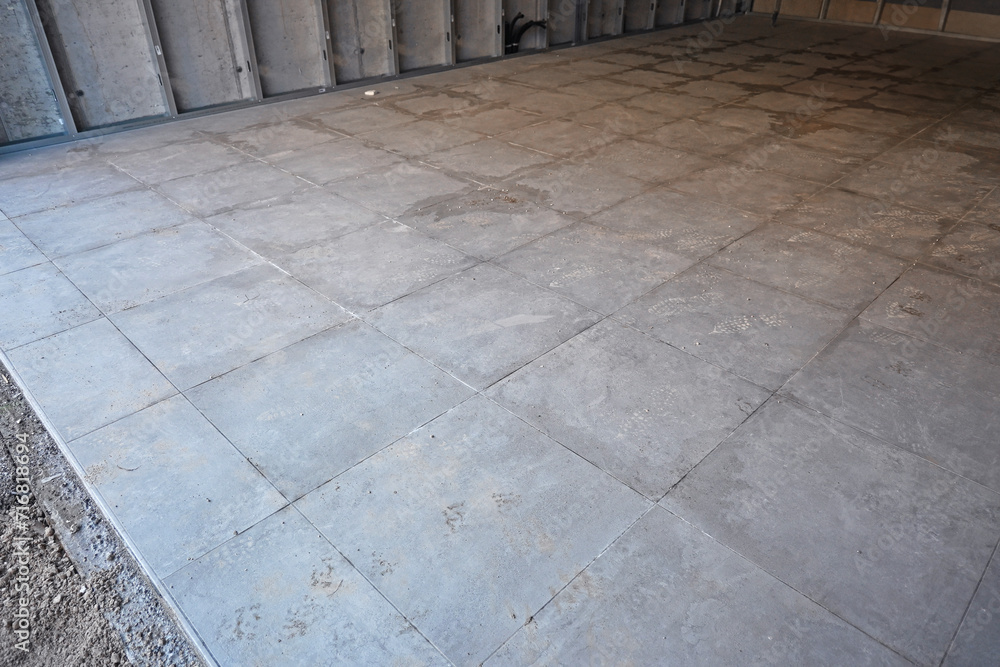 Posa e creazione di pavimento di piastrelle grigie 