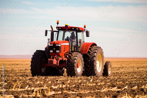 A red tractor plows the field  preparing the land for sowing crops during a bright day on a farm.