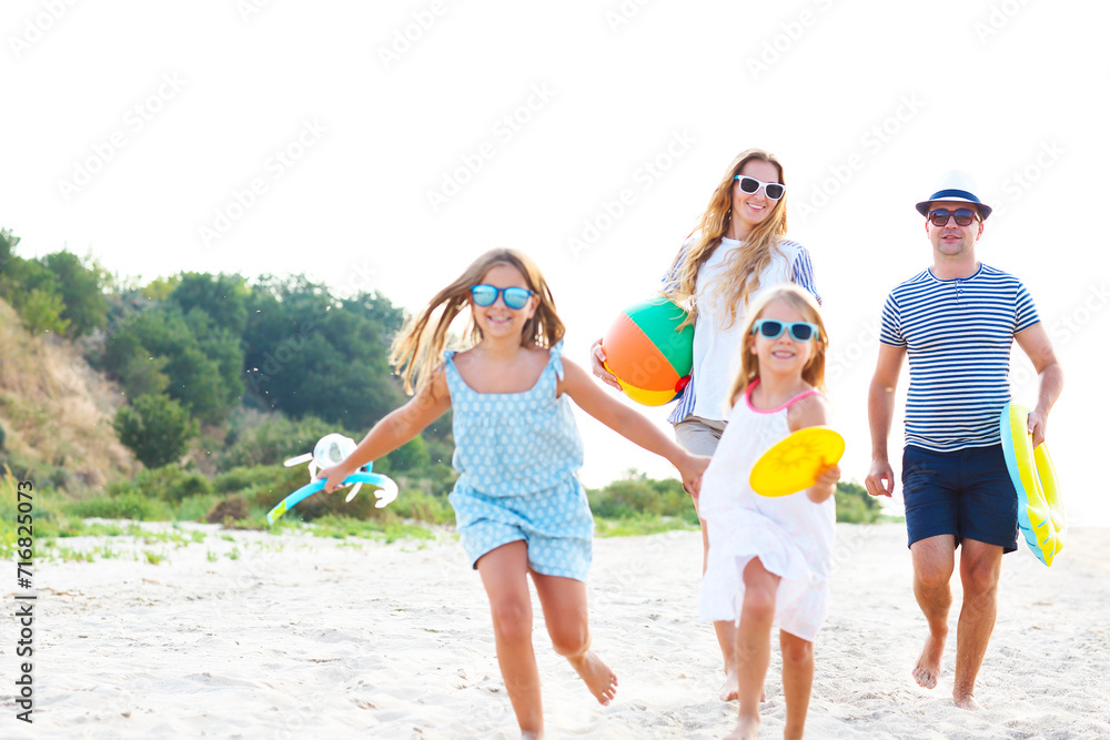 Family with children running at the beach Family with children running at the beach