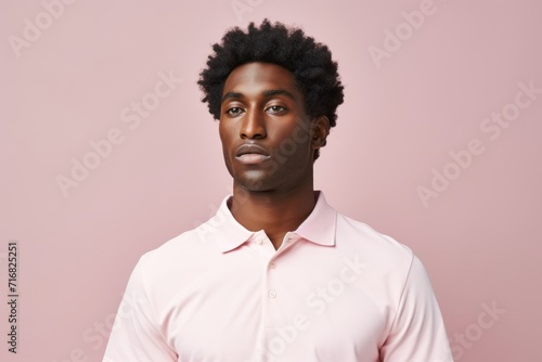 Portrait of a tender afro-american man in his 30s wearing a breathable golf polo against a pastel or soft colors background. AI Generation © CogniLens