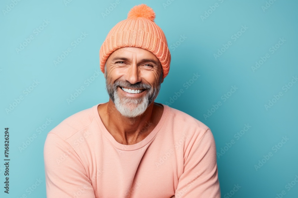 Portrait of a happy man in his 40s sporting a trendy beanie against a pastel or soft colors background. AI Generation Portrait of a happy man in his 40s sporting a trendy beanie against a pastel or soft colors background. AI Generation