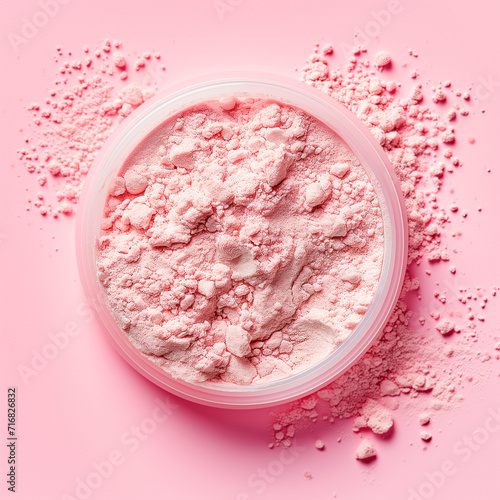 Measuring spoon with collagen powder or alginate mask on pink background.