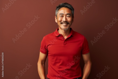 Portrait of a glad asian man in his 40s donning a trendy cropped top against a minimalist or empty room background. AI Generation