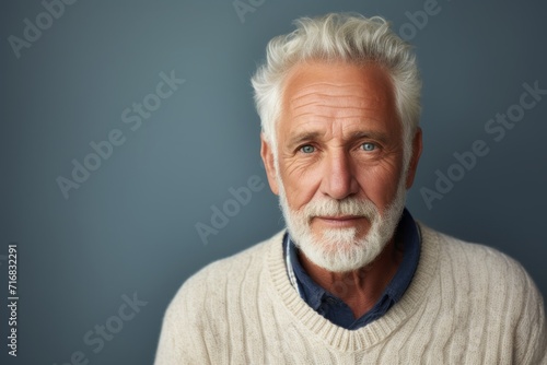 Portrait of a content man in his 60s wearing a chic cardigan against a minimalist or empty room background. AI Generation photo