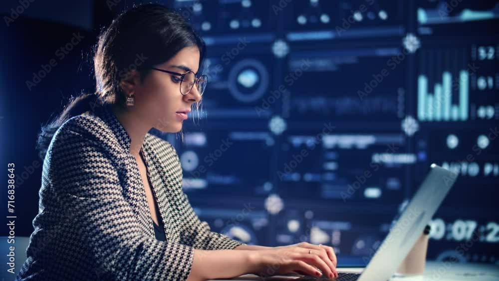 Woman big data engineer working laptop chart diagram analyzing futuristic infographic hi tech screen Woman big data engineer working laptop chart diagram analyzing futuristic infographic hi tech screen