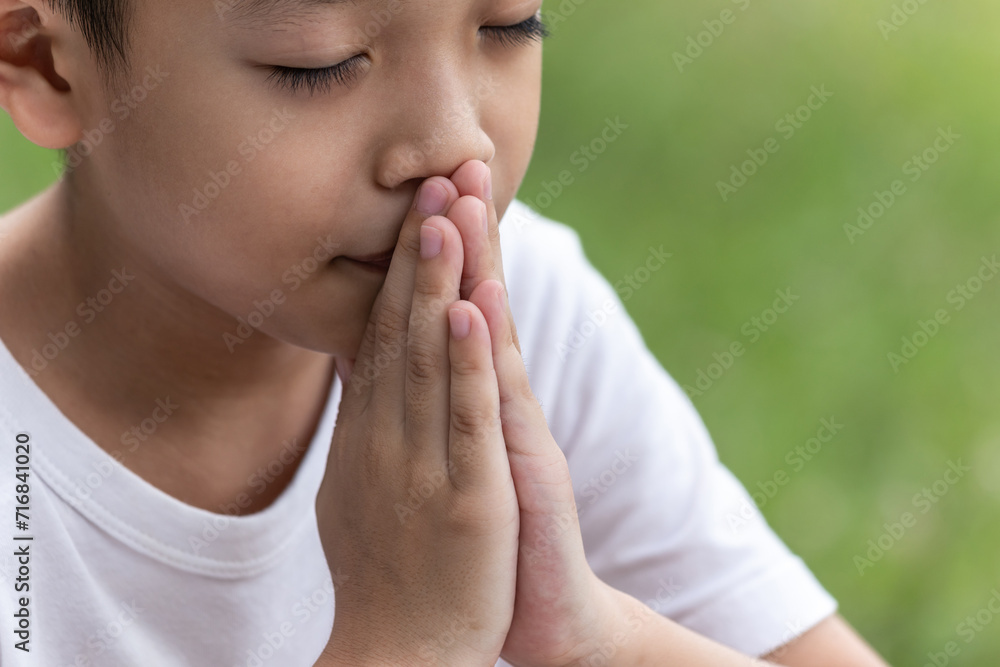 Little boy with Bible praying and close your eyes in praying. Prayer to pray. Children pray with folded hands. Little boy with Bible praying and close your eyes in praying. Prayer to pray. Children pray with folded hands.
