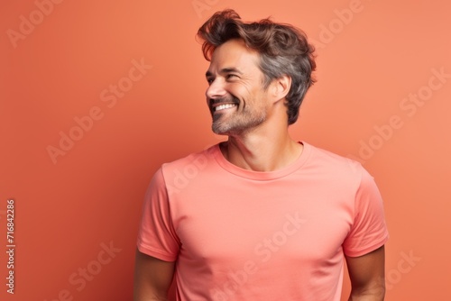 Portrait of a blissful man in his 30s dressed in a casual t-shirt against a solid color backdrop. AI Generation © CogniLens