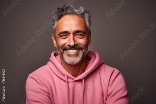 Portrait of a joyful man in his 50s wearing a thermal fleece pullover against a solid color backdrop. AI Generation