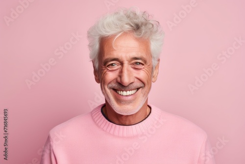 Portrait of a grinning man in his 80s showing off a thermal merino wool top against a solid color backdrop. AI Generation