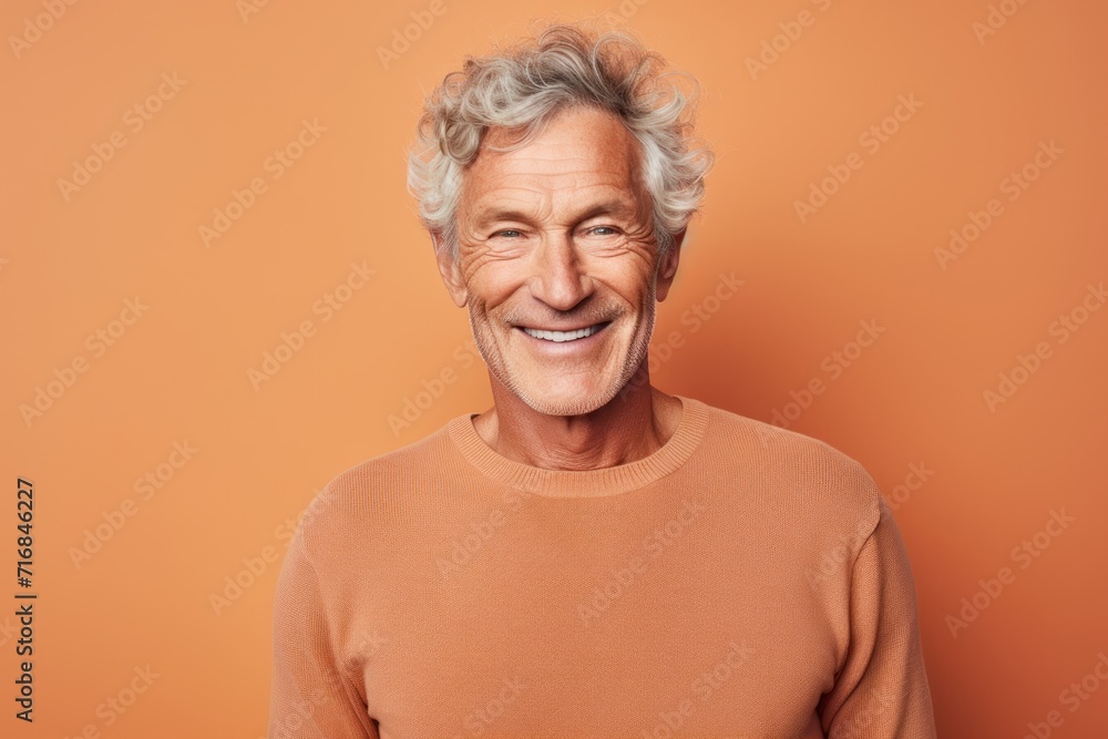 Portrait of a grinning man in his 70s showing off a thermal merino wool top against a solid color backdrop. AI Generation Portrait of a grinning man in his 70s showing off a thermal merino wool top against a solid color backdrop. AI Generation
