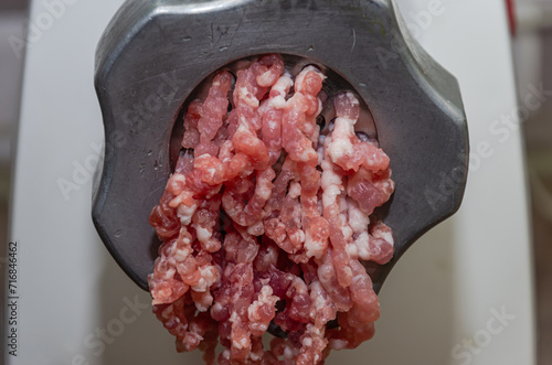 Minced meat in a meat grinder, close-up