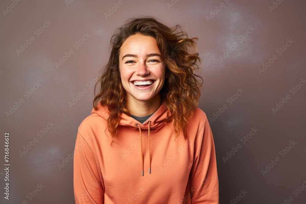Portrait of a grinning woman in her 20s wearing a thermal fleece pullover against a solid color backdrop. AI Generation Portrait of a grinning woman in her 20s wearing a thermal fleece pullover against a solid color backdrop. AI Generation
