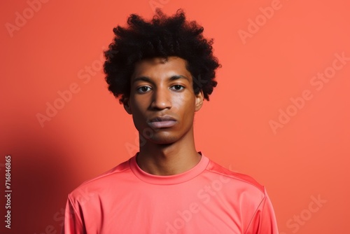 Portrait of a tender afro-american man in his 20s sporting a breathable mesh jersey against a solid color backdrop. AI Generation