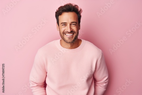 Portrait of a joyful man in his 30s wearing a cozy sweater against a solid pastel color wall. AI Generation