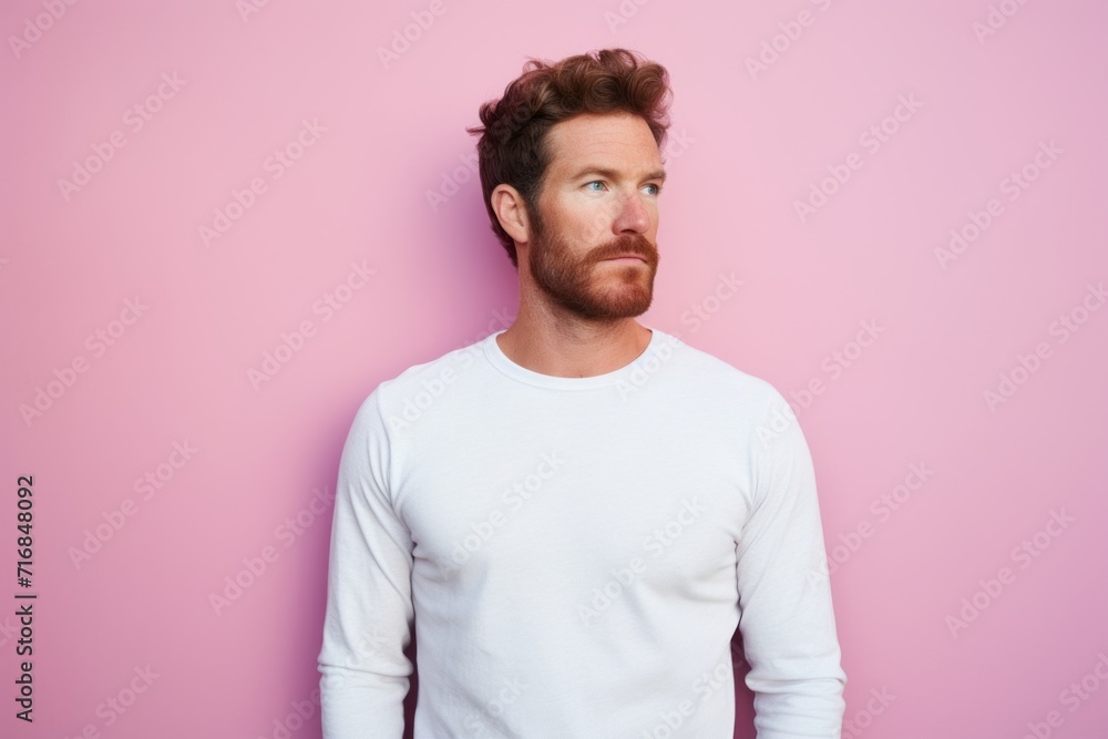 Portrait of a tender man in his 30s showing off a thermal merino wool top against a solid pastel color wall. AI Generation Portrait of a tender man in his 30s showing off a thermal merino wool top against a solid pastel color wall. AI Generation