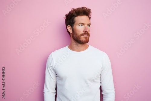 Portrait of a tender man in his 30s showing off a thermal merino wool top against a solid pastel color wall. AI Generation © CogniLens