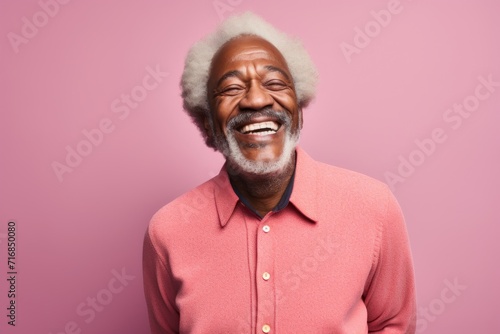 Portrait of a cheerful afro-american man in his 60s dressed in a warm wool sweater against a solid pastel color wall. AI Generation