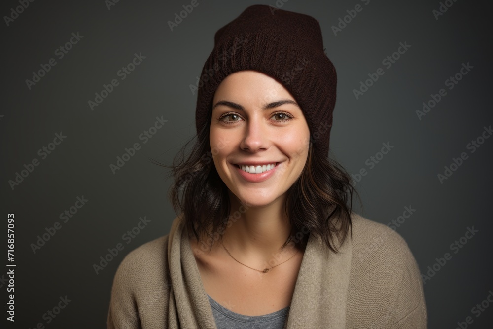 Portrait of a grinning woman in her 30s donning a warm wool beanie against a blank studio backdrop. AI Generation Portrait of a grinning woman in her 30s donning a warm wool beanie against a blank studio backdrop. AI Generation
