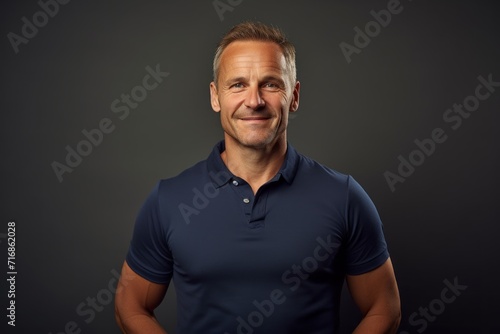 Portrait of a jovial man in his 40s wearing a sporty polo shirt against a light wood minimalistic setup. AI Generation