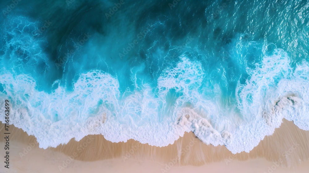 an aerial view of a beach with waves crashing on it and a blue ocean in the background, with a white sand beach and a blue sky