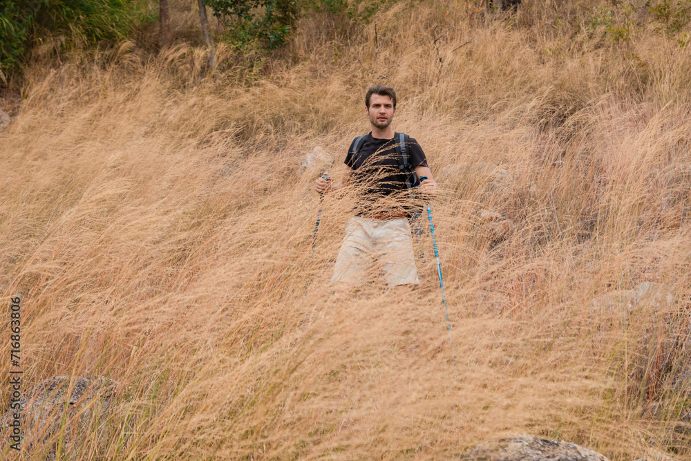 Smart active sport male happy hiking walking to the top of mountain in holiday autumn vacation, backpack tourist man enjoy exercise outdoors adventure trip traveling lifestyle, healthy athletic man Smart active sport male happy hiking walking to the top of mountain in holiday autumn vacation, backpack tourist man enjoy exercise outdoors adventure trip traveling lifestyle, healthy athletic man